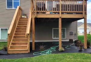 Second story stained wood deck with stairway to back yard - front view