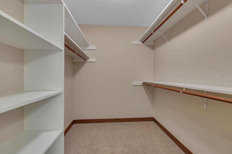 Large closet room with shelves and rods