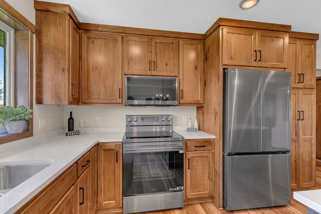 Wood kitchen cabinetry with stainless steel appliances