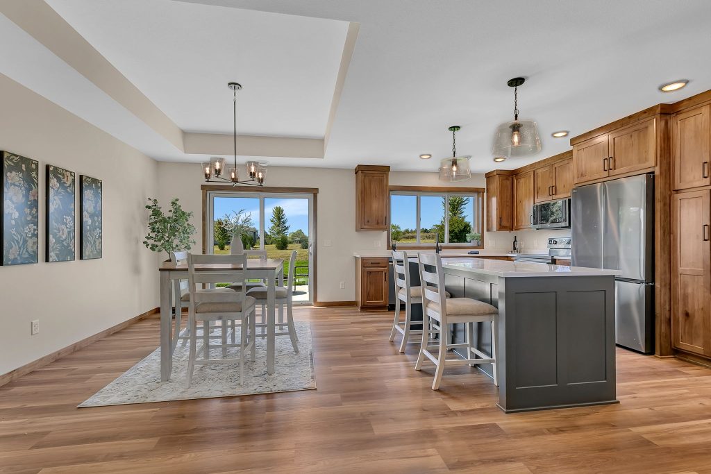 Open kitchen and dining area with raised ceiling
