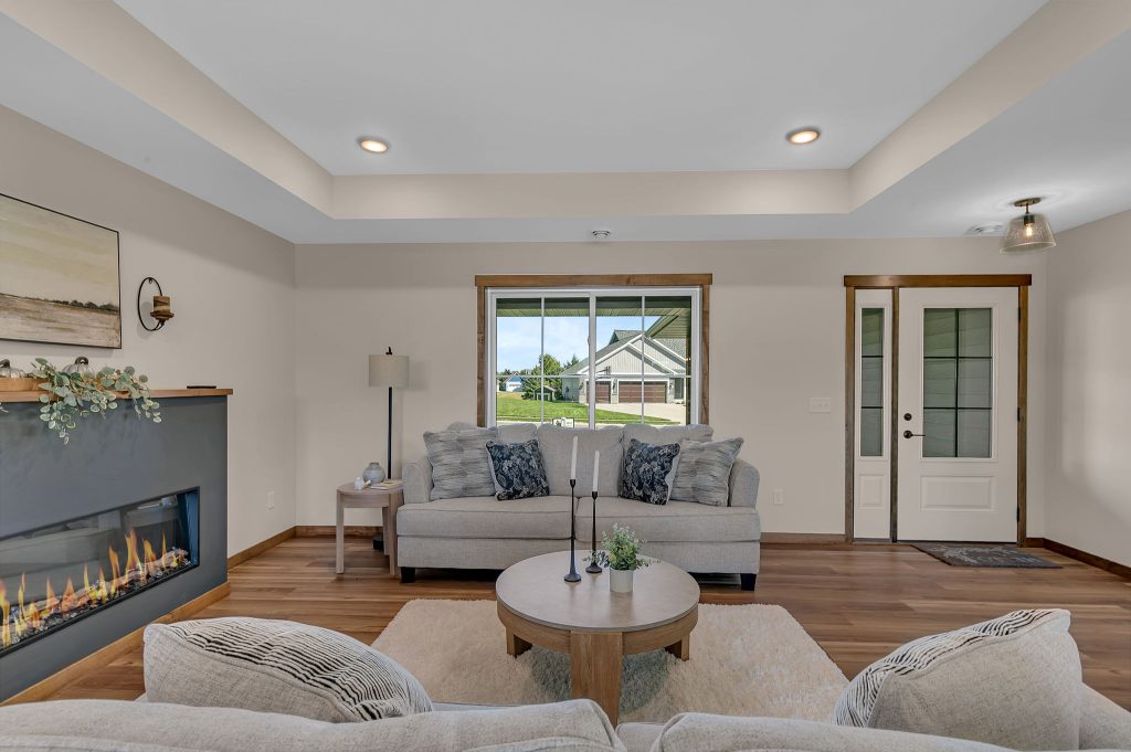 Living room with modern fireplace and front door